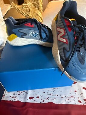 New Balance Kids Navy Blue Sneakers with Red and Yellow Accents